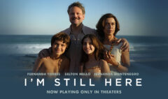 Poster of the Brazilian movie "I'm Still Here" (Ainda Estou Aqui), featuring Fernanda Torres, Selton Mello, and Fernanda Montenegro, with a family standing by the beach.