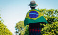 Farmer at coffee plantation holding Brazilian flag