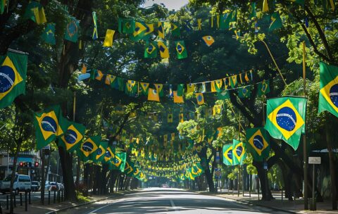 uma-rua-alinhada-por-arvores-com-bandeiras-que-dizem-clube-de-citacao