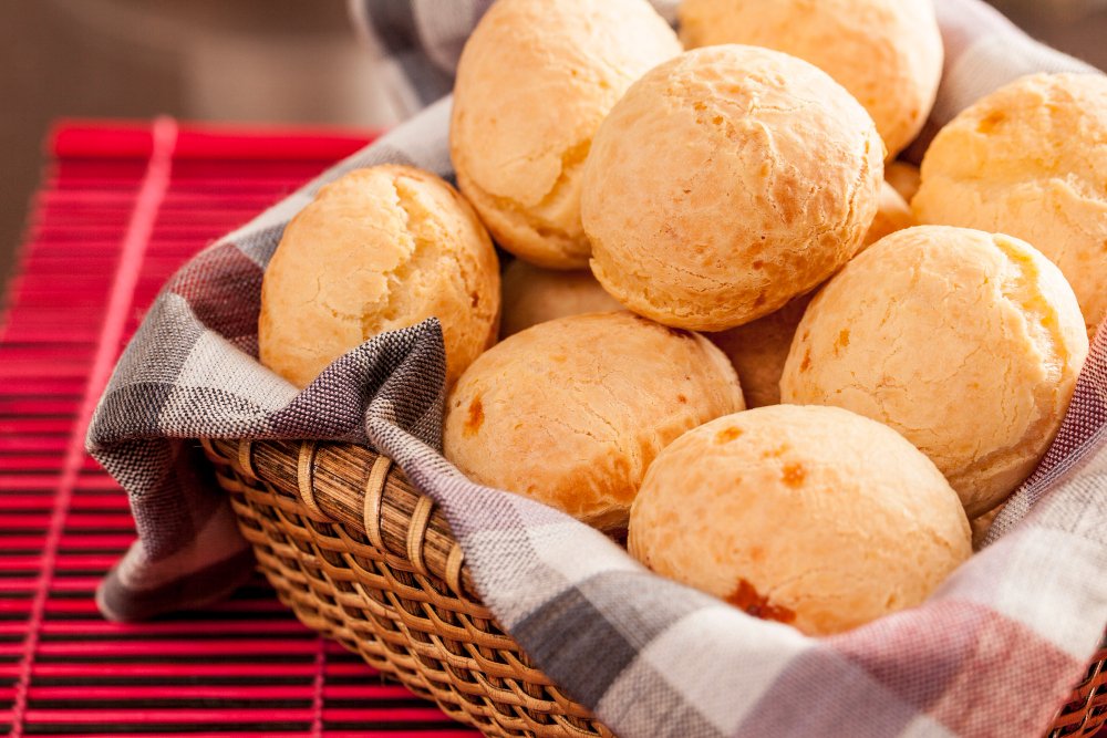 Brazilian pão de queijo served in a cloth-lined wicker basket